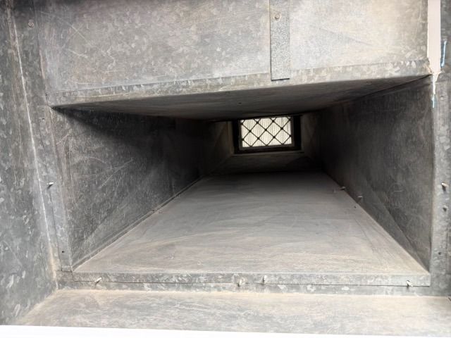 Cleaned interior of a second rectangular duct run, bare metal walls and the register at the end